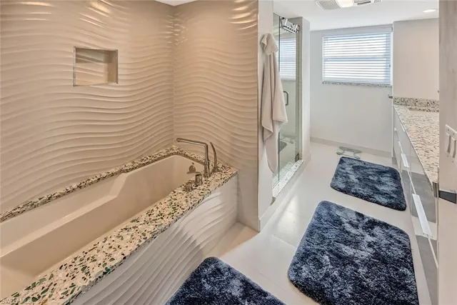 a bathroom with a bathtub and shower