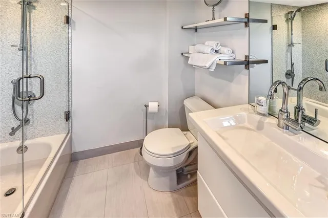 a bathroom with a sink vanity mirror and toilet