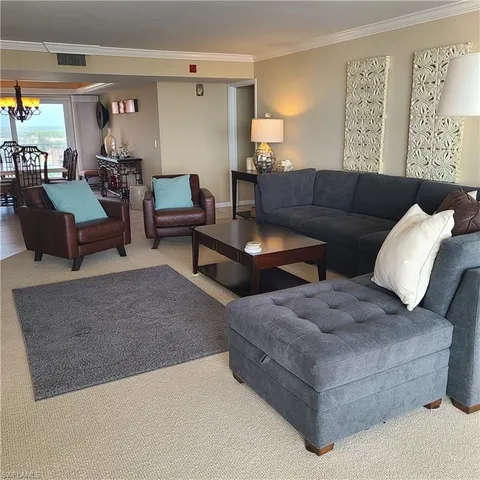 a living room with furniture and white walls