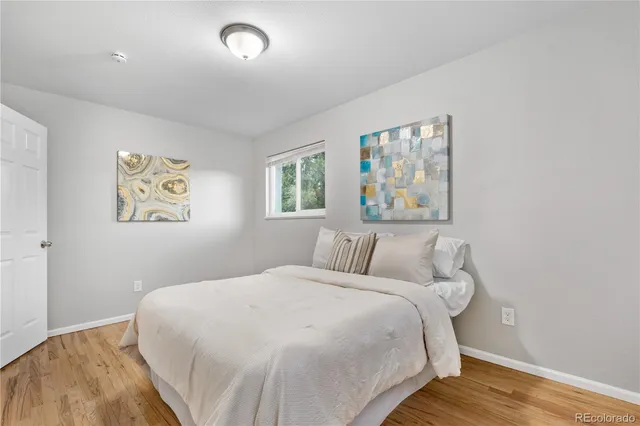 a bedroom with a large bed and a window