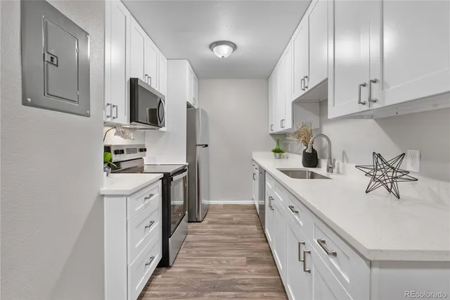 a kitchen with stainless steel appliances a sink stove and cabinets