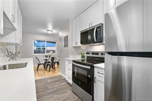 a kitchen with stainless steel appliances a stove microwave and a refrigerator