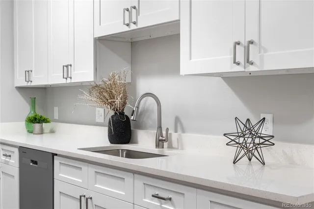 a kitchen with a potted plant on the counter and cabinets