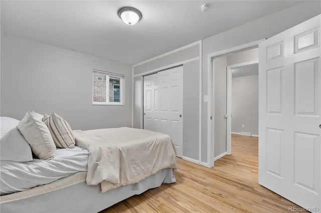 a bedroom with a bed and a painting on the wall