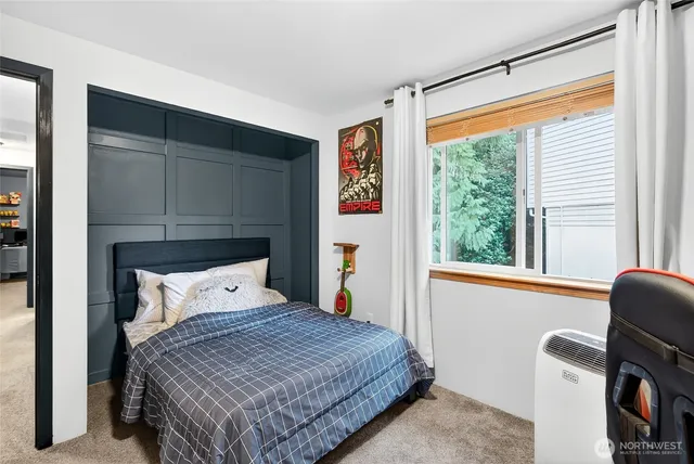 a bedroom with a bed and a large window