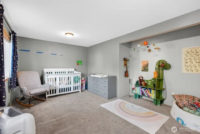 a bedroom with furniture and a wooden floor