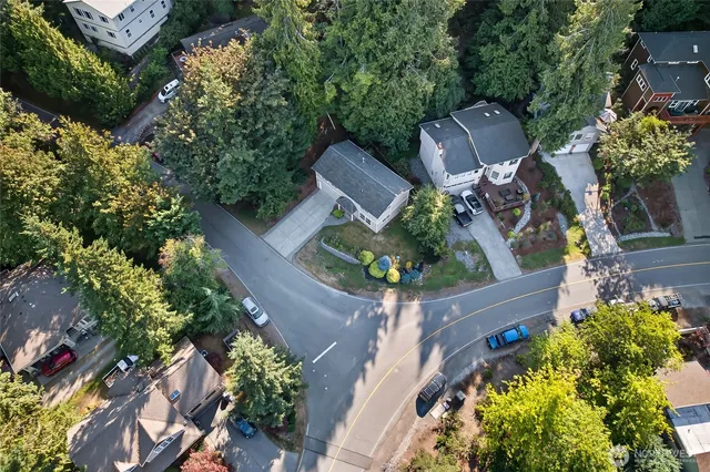 an aerial view of a house with garden space and street view