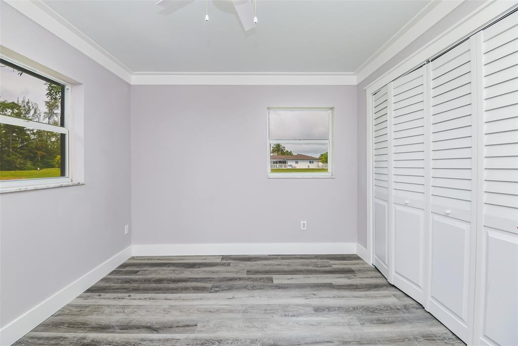 22500 Labrador Street Boca Raton, FL 33428 - Photo 22 of 27 a view of an empty room with wooden floor and a window