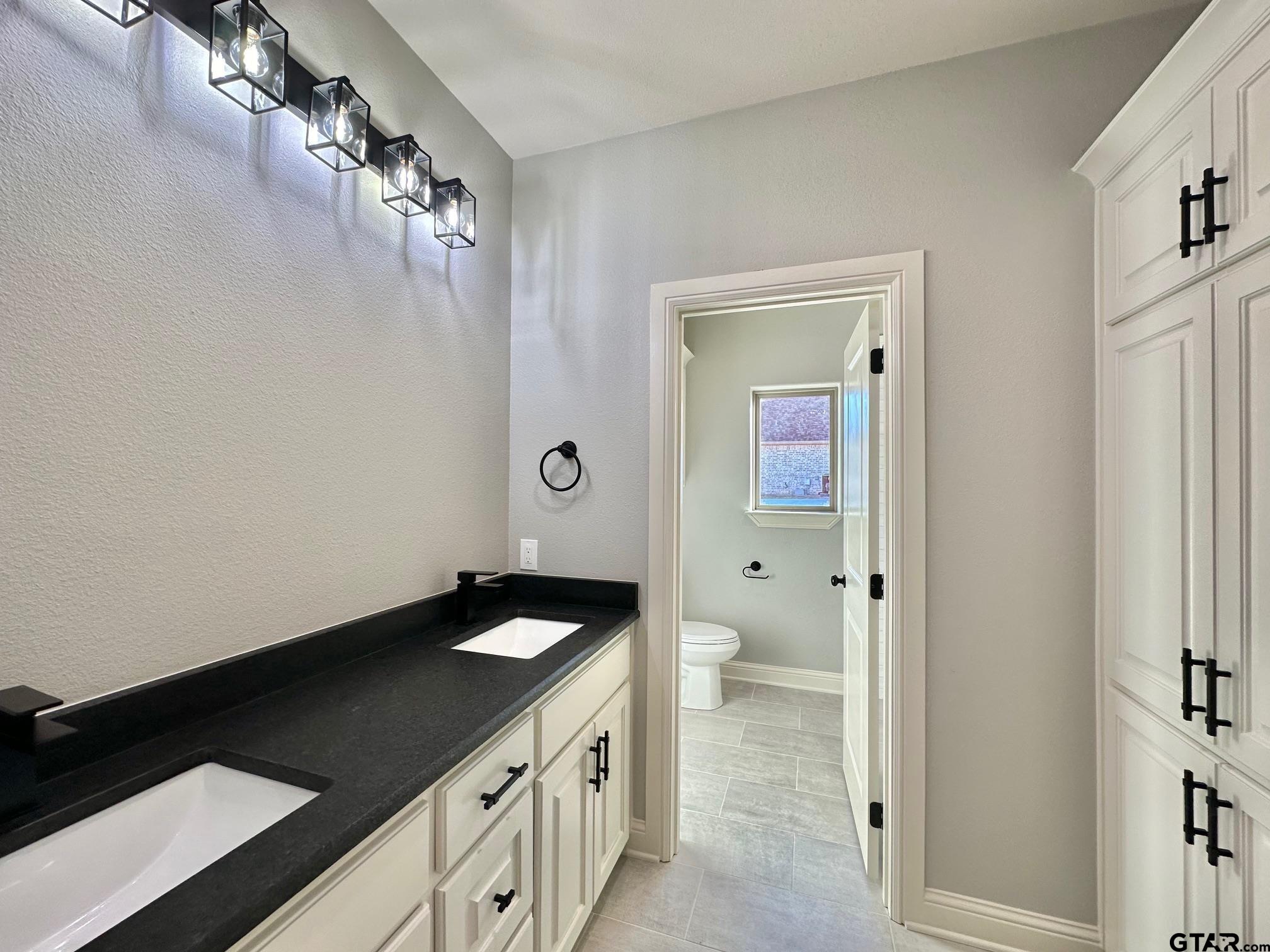 229 Brooks Drive Gladewater, TX 75647 - Photo 41 of 46 a view of a bathroom with a sink and a mirror