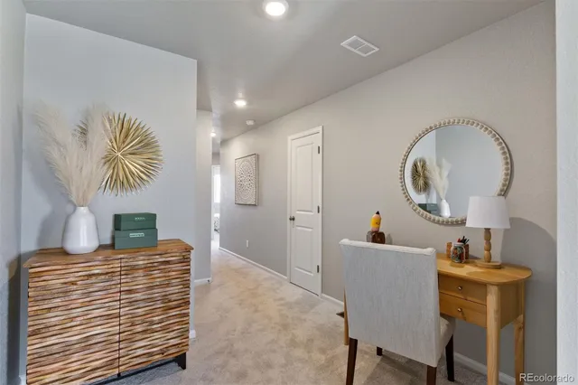 a view of a hallway with couches and chandelier