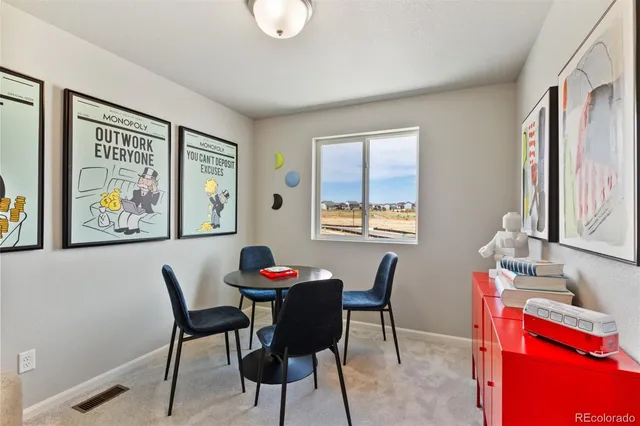 a view of a dining room with furniture and a window