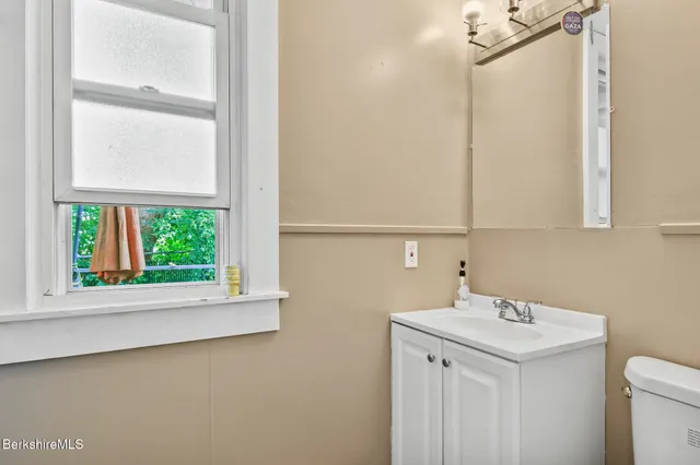 a bathroom with a sink a vanity and a window