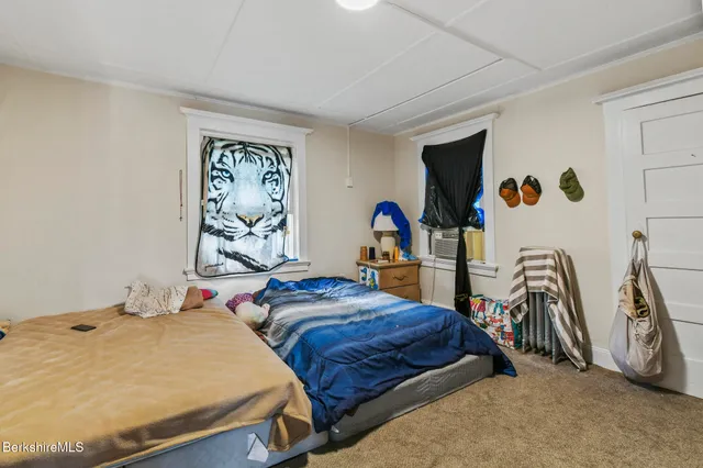 a bedroom with two beds and a table