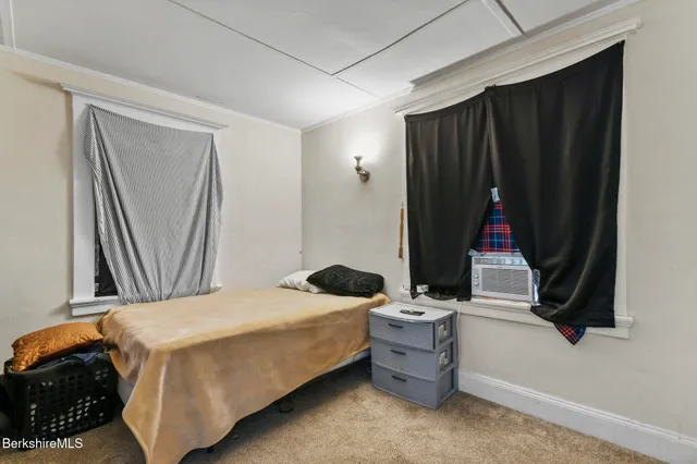 a bedroom with a bed and a mirror