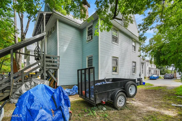 a blue house with trees in front of it