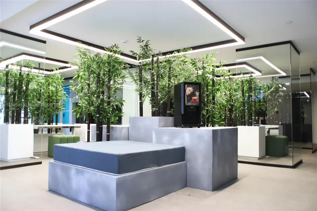 a kitchen with a large window stainless steel appliances and wooden floor