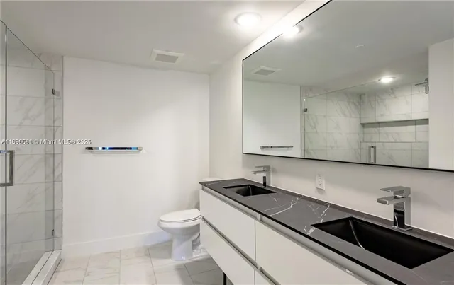 a bathroom with a sink a toilet and bathtub