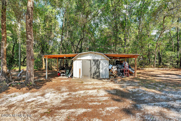 6519 Neale Road Melrose, FL 32666 - Photo 11 of 57 a view of a chairs and table in the patio next to a yard