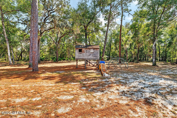 6519 Neale Road Melrose, FL 32666 - Photo 12 of 57 a bench sitting in the middle of a yard