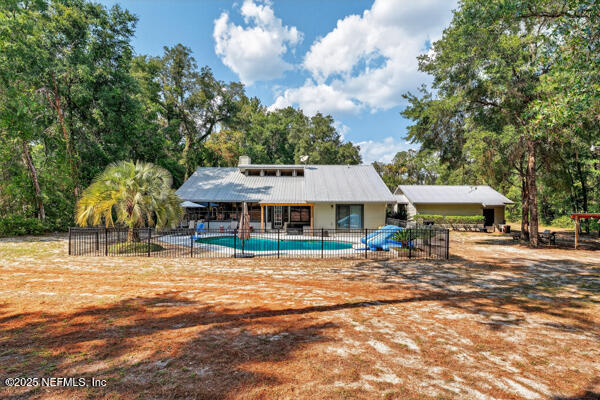 6519 Neale Road Melrose, FL 32666 - Photo 15 of 57 a backyard of a house with barbeque oven table and chairs