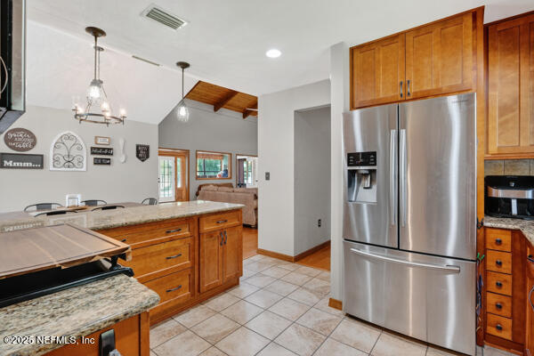 6519 Neale Road Melrose, FL 32666 - Photo 20 of 57 a kitchen with stainless steel appliances granite countertop a refrigerator a sink dishwasher a stove with wooden floor