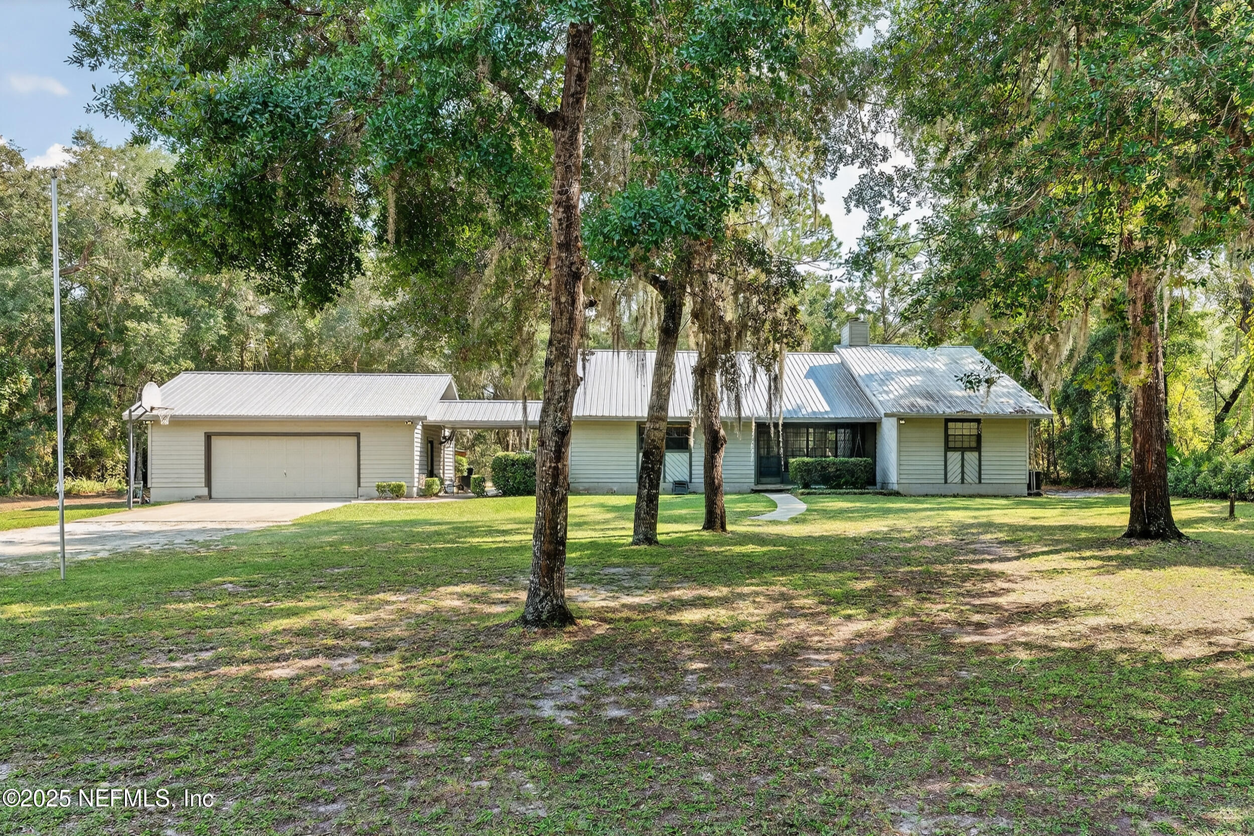 6519 Neale Road Melrose, FL 32666 - Photo 2 of 57 a house with a big yard and large trees