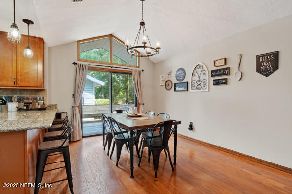 6519 Neale Road Melrose, FL 32666 - Photo 23 of 57 a view of a dining room with furniture and a chandelier