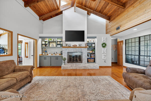 6519 Neale Road Melrose, FL 32666 - Photo 24 of 57 a living room with furniture a flat screen tv and a fireplace