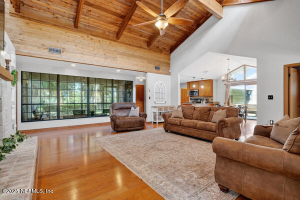6519 Neale Road Melrose, FL 32666 - Photo 26 of 57 a living room with furniture and a floor to ceiling window