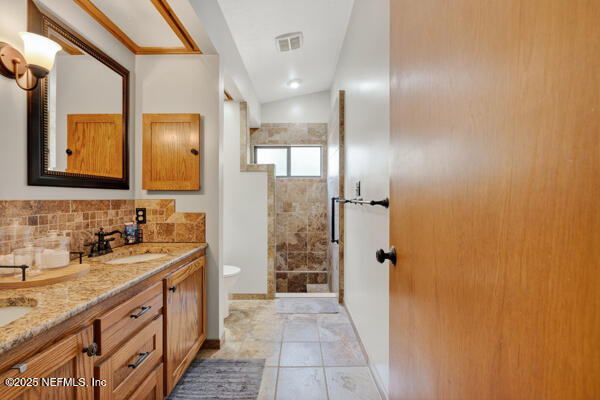 6519 Neale Road Melrose, FL 32666 - Photo 33 of 57 a bathroom with a double vanity sink mirror and shower