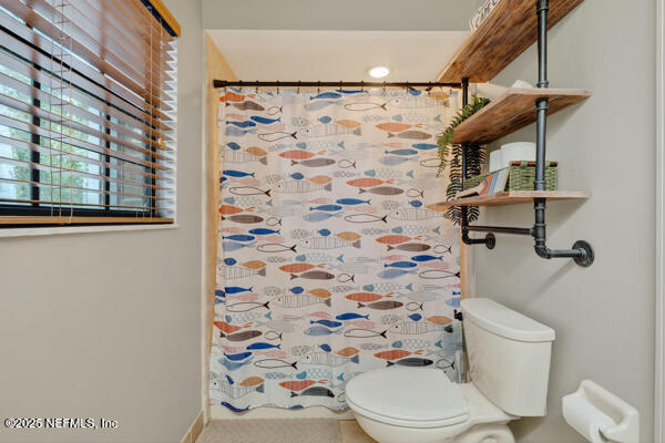 6519 Neale Road Melrose, FL 32666 - Photo 43 of 57 a bathroom with a toilet and a shower curtain