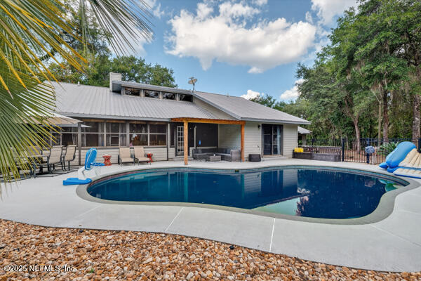 6519 Neale Road Melrose, FL 32666 - Photo 49 of 57 a view of house with swimming pool and outdoor seating