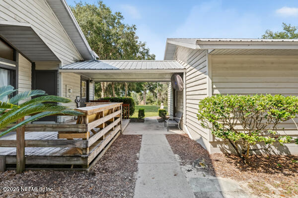 6519 Neale Road Melrose, FL 32666 - Photo 7 of 57 a view of a porch with furniture and a yard