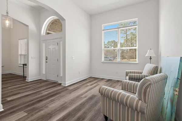 a bedroom with a bed a couch and dresser