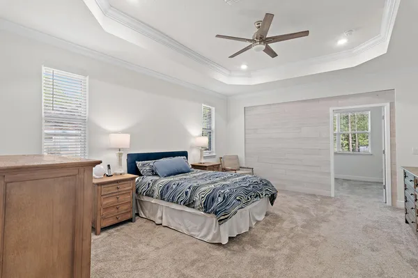 an empty room with a window and a ceiling fan