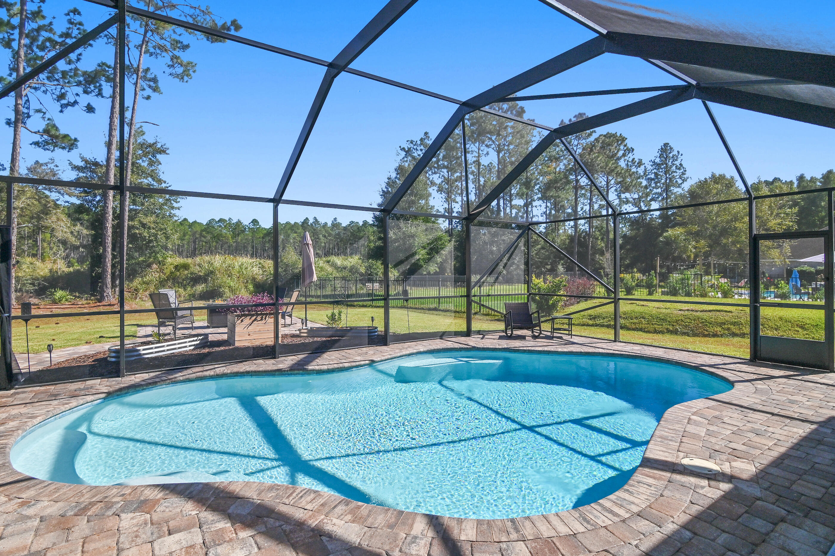588 Windswept Boulevard Freeport, FL 32439 - Photo 2 of 62 a view of a swimming pool with a porch