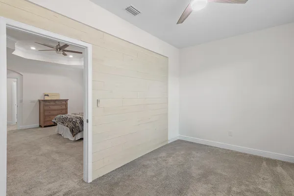 a view of walk in closet with clothes