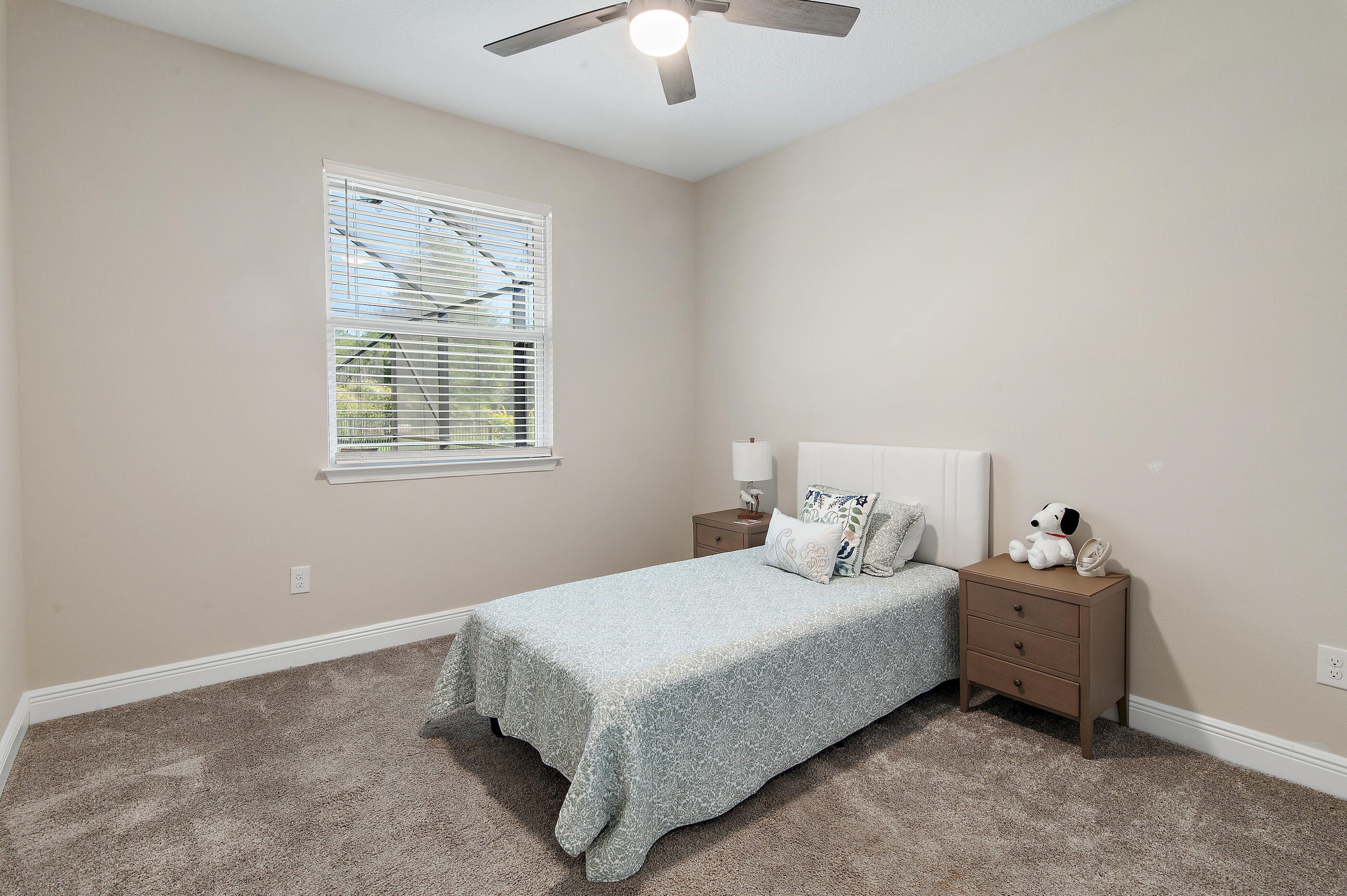 588 Windswept Boulevard Freeport, FL 32439 - Photo 28 of 62 a bedroom with a bed and a chandelier