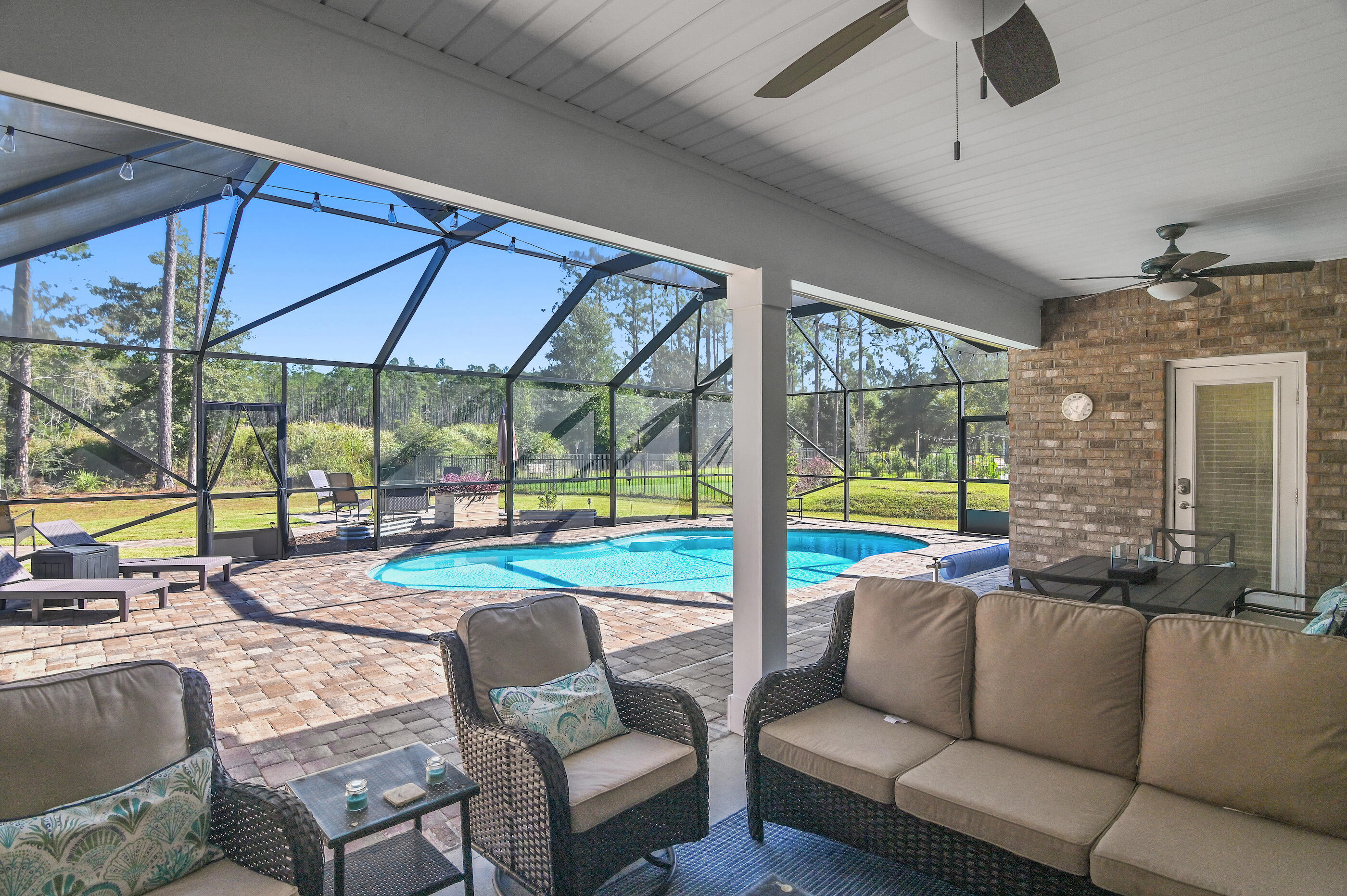 588 Windswept Boulevard Freeport, FL 32439 - Photo 37 of 62 a living room with furniture and a floor to ceiling window