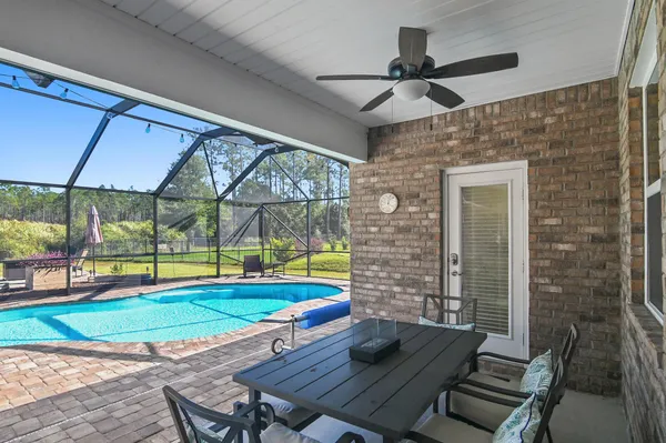 a backyard of a house with a yard and outdoor seating