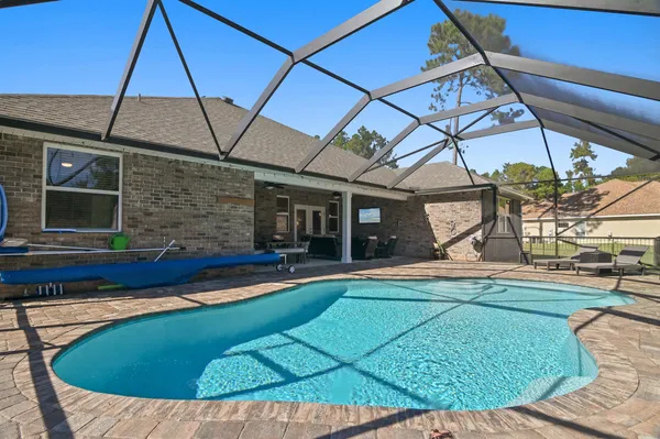 a view of a patio with a table and chairs under an umbrella