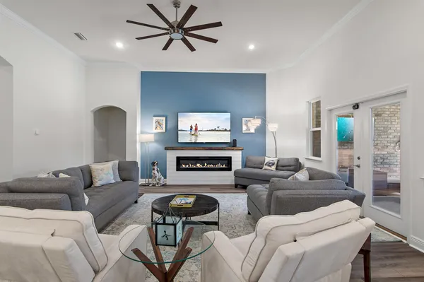 a living room with furniture kitchen and a table