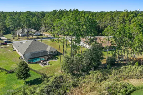 a view of a house with backyard sitting area and garden