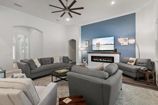a kitchen with a sink stove and wooden floor