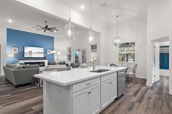 a kitchen with granite countertop white cabinets and white appliances