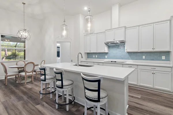 a kitchen with refrigerator and cabinets