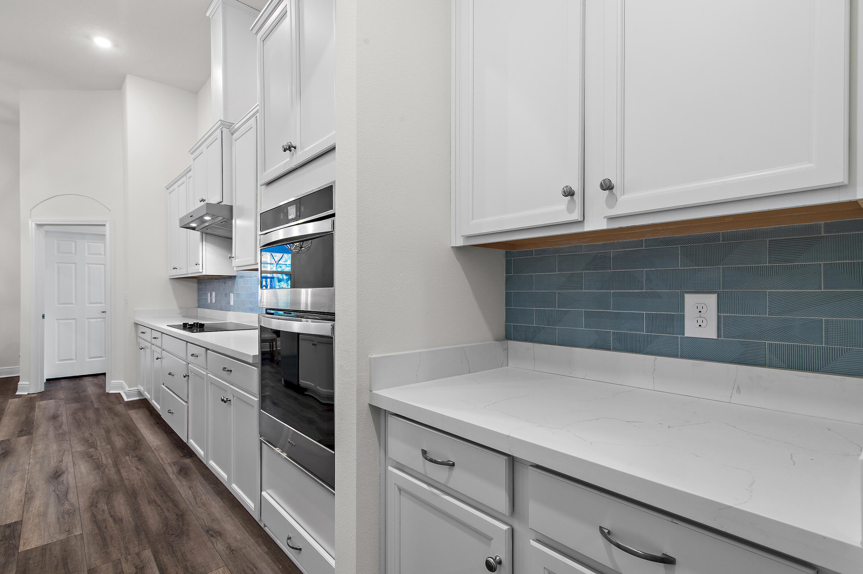 588 Windswept Boulevard Freeport, FL 32439 - Photo 10 of 62 a kitchen with granite countertop white cabinets and white appliances