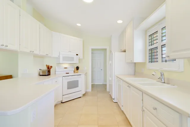 a kitchen with a sink cabinets and window