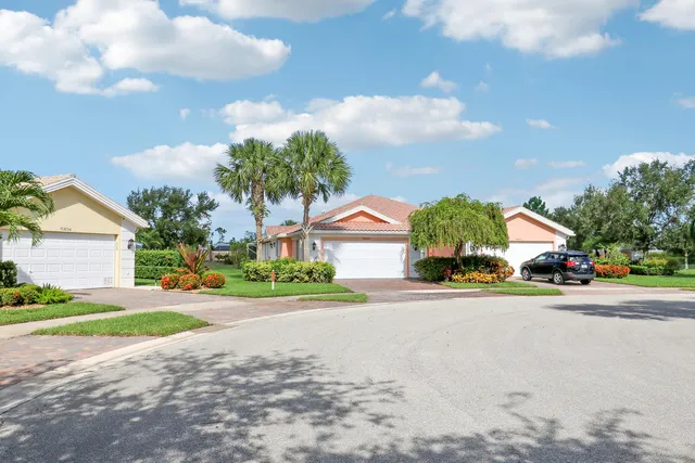 a front view of house with a yard and a garage