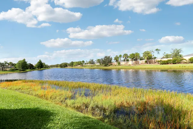 a view of a house with a yard and a fountain